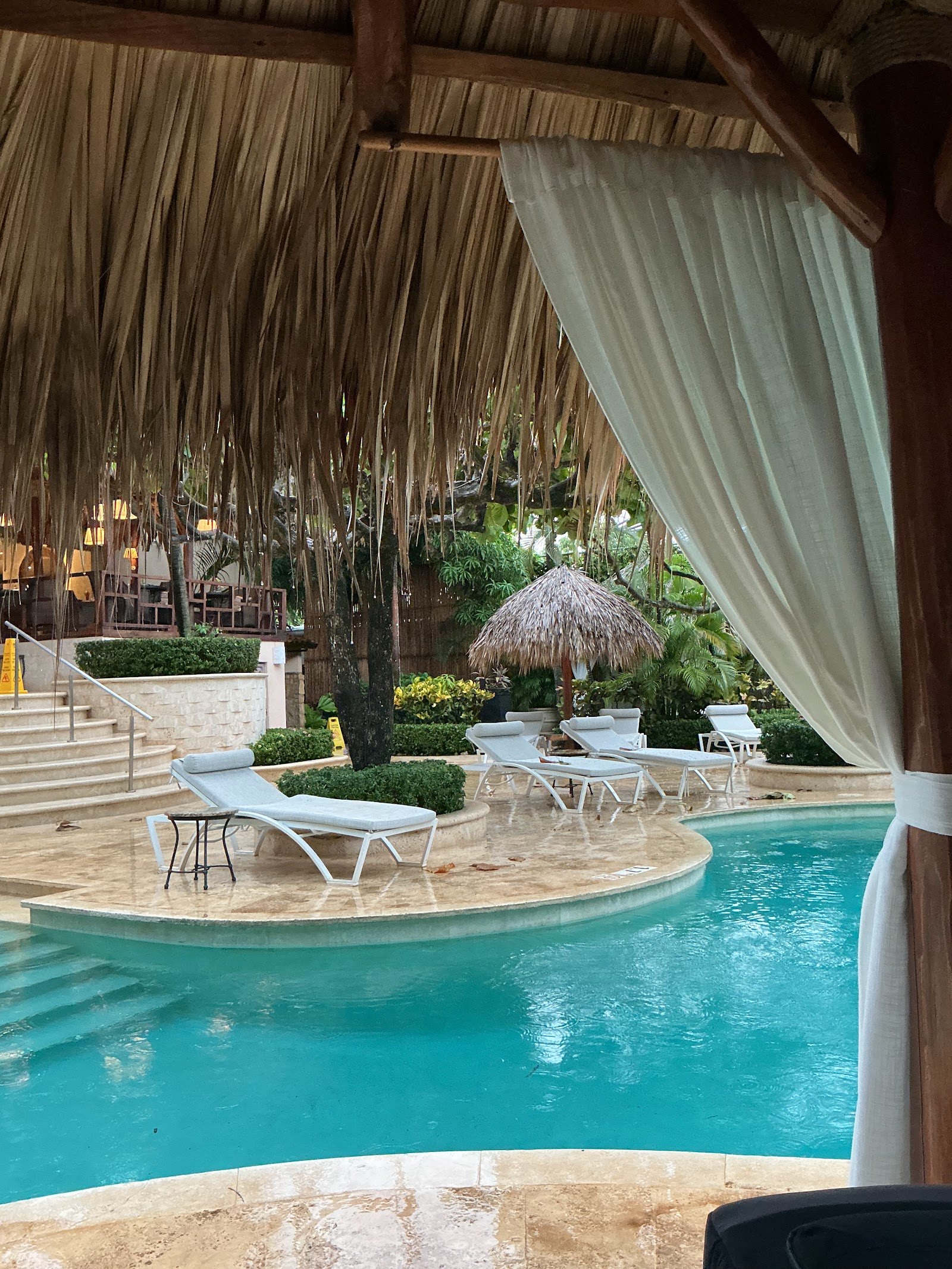 Hotel pool under a thatched palapa roof in Tamarindo, Costa Rica